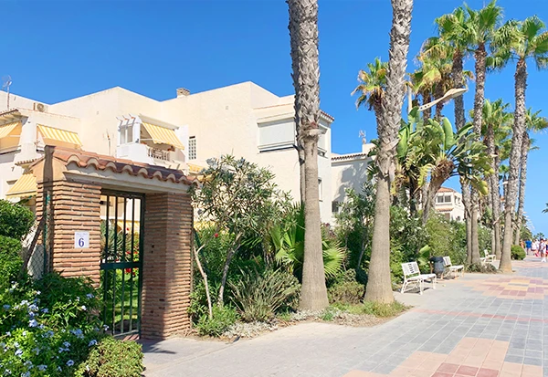 Exterior view of a house for rent in Torrox Costa, Spain, with a sunny setting and sea views