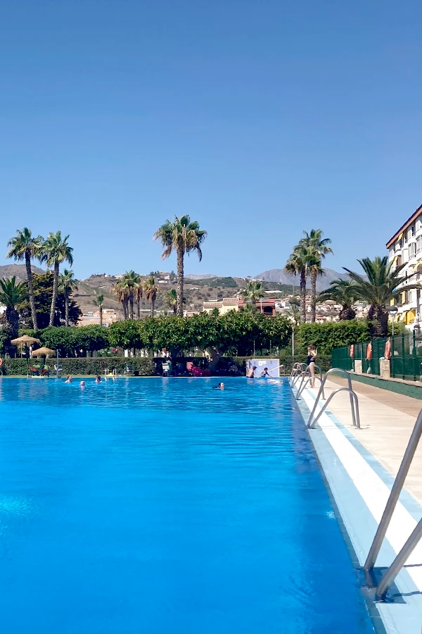 Swimming pool with a view of the mountains at a house in Torrox Costa, Spain, under a clear sky